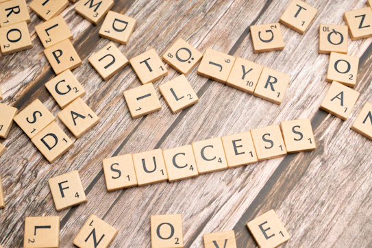scrabble tiles spelling out the word love on a wooden surface
