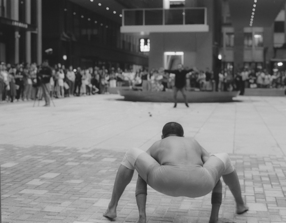 a man is doing a handstand in front of a crowd