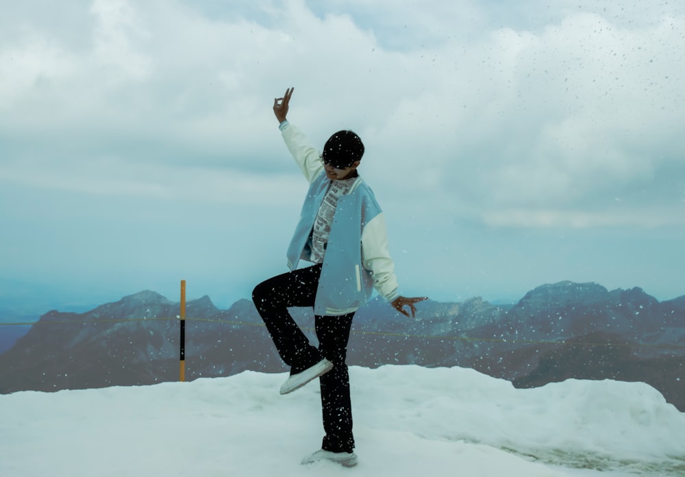 a person standing on top of a snow covered hill