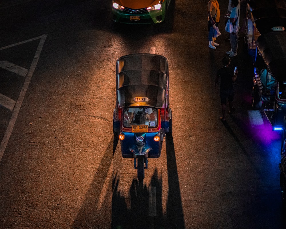 a car driving down a street at night