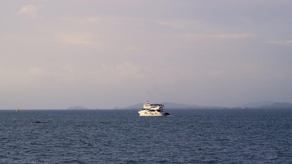 a white boat in the middle of a large body of water