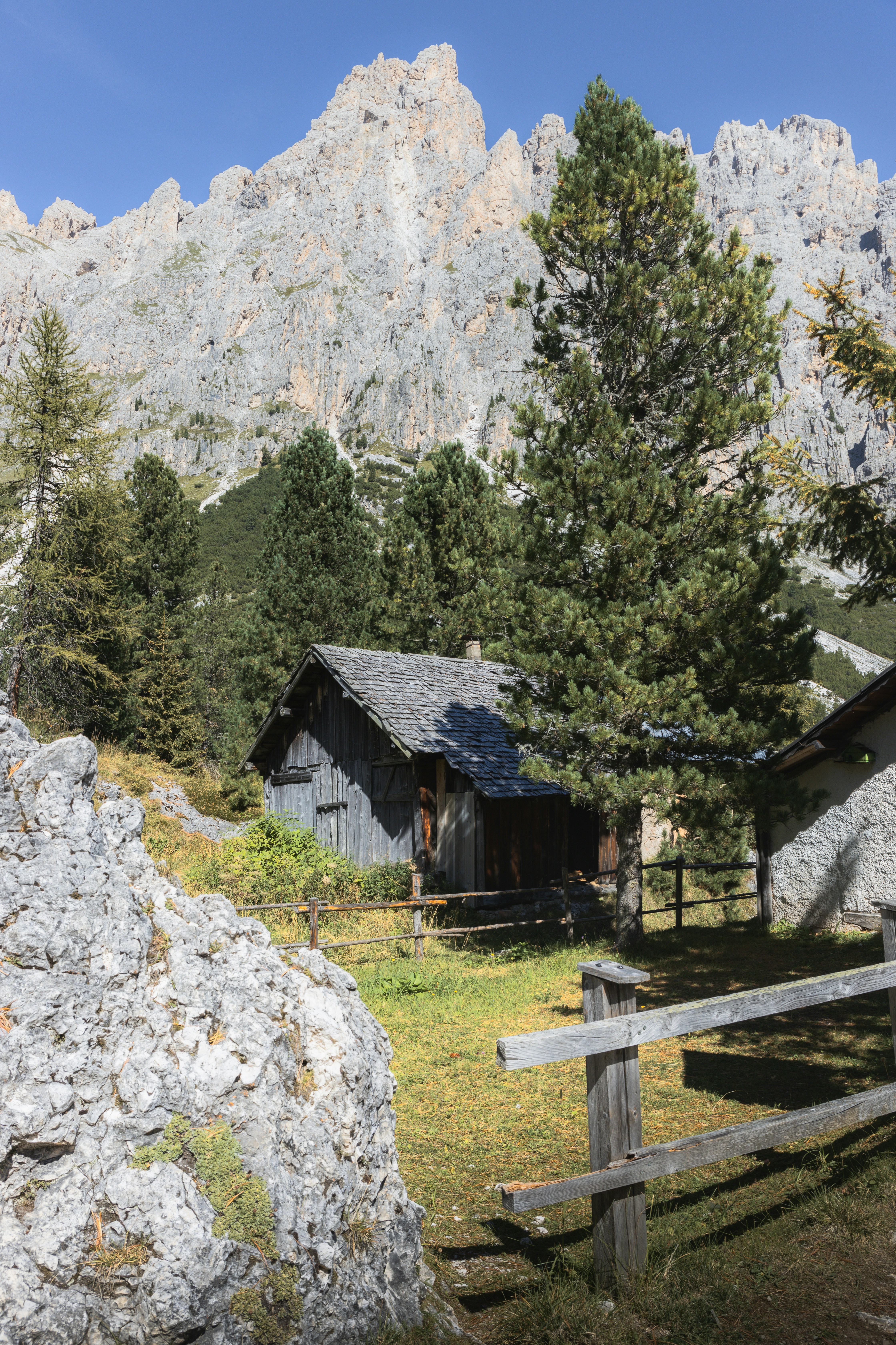 a cabin in the mountains with a mountain in the background