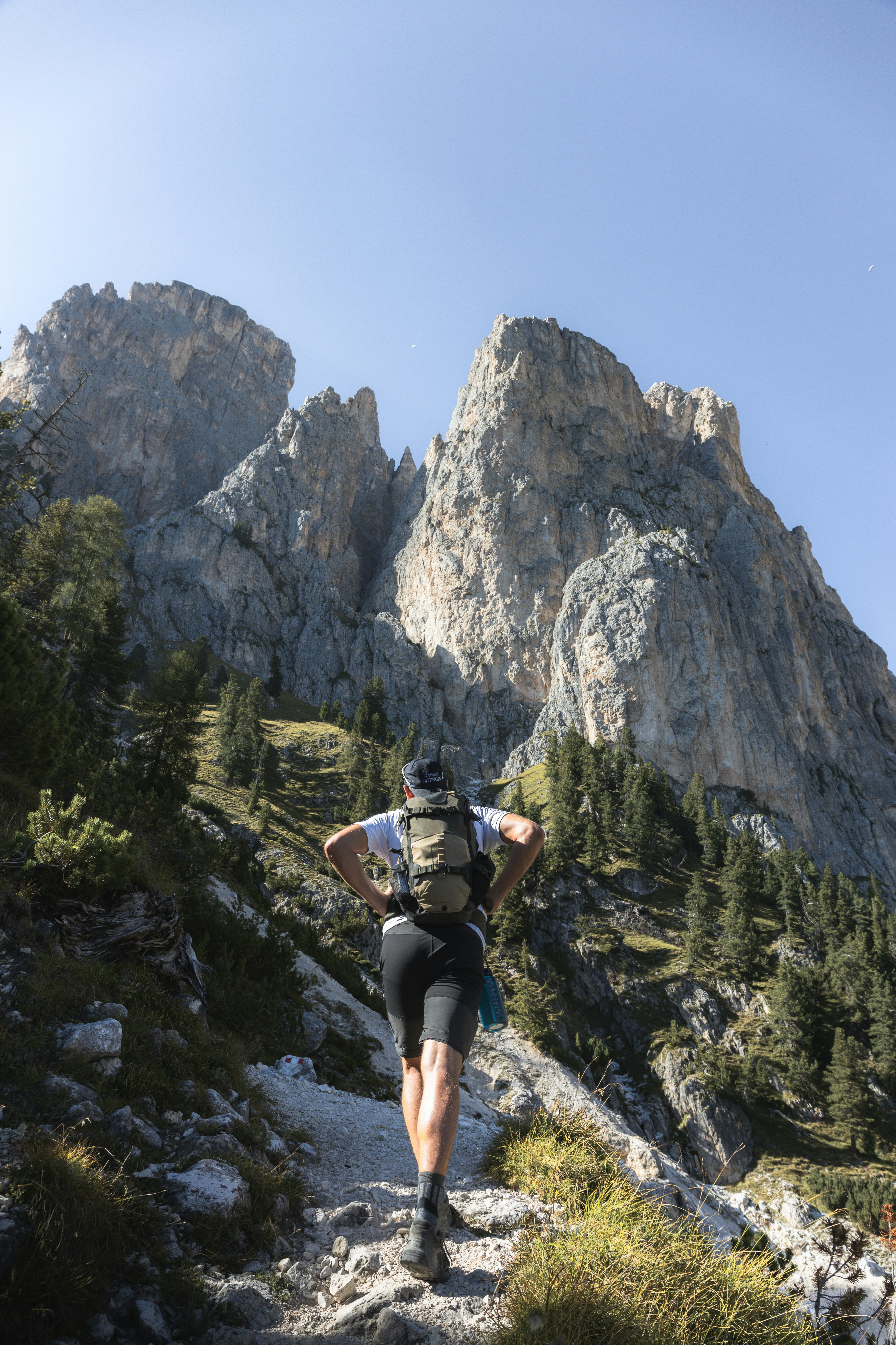 a man with a backpack is hiking up a mountain