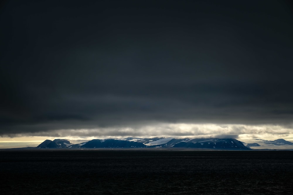 a large body of water under a cloudy sky