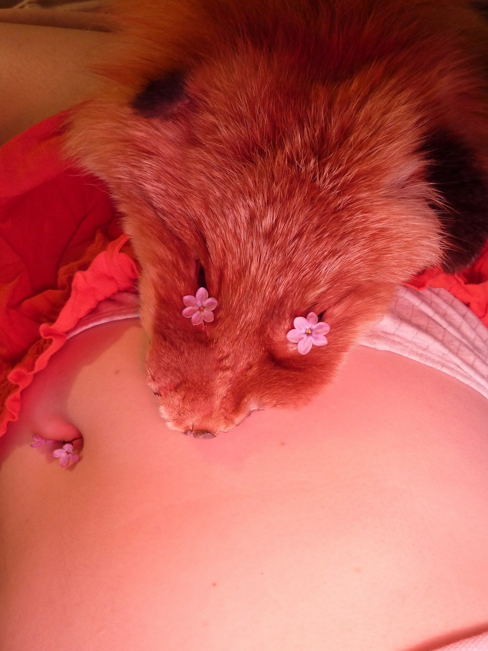 a close up of a person's stomach with a small flower on it