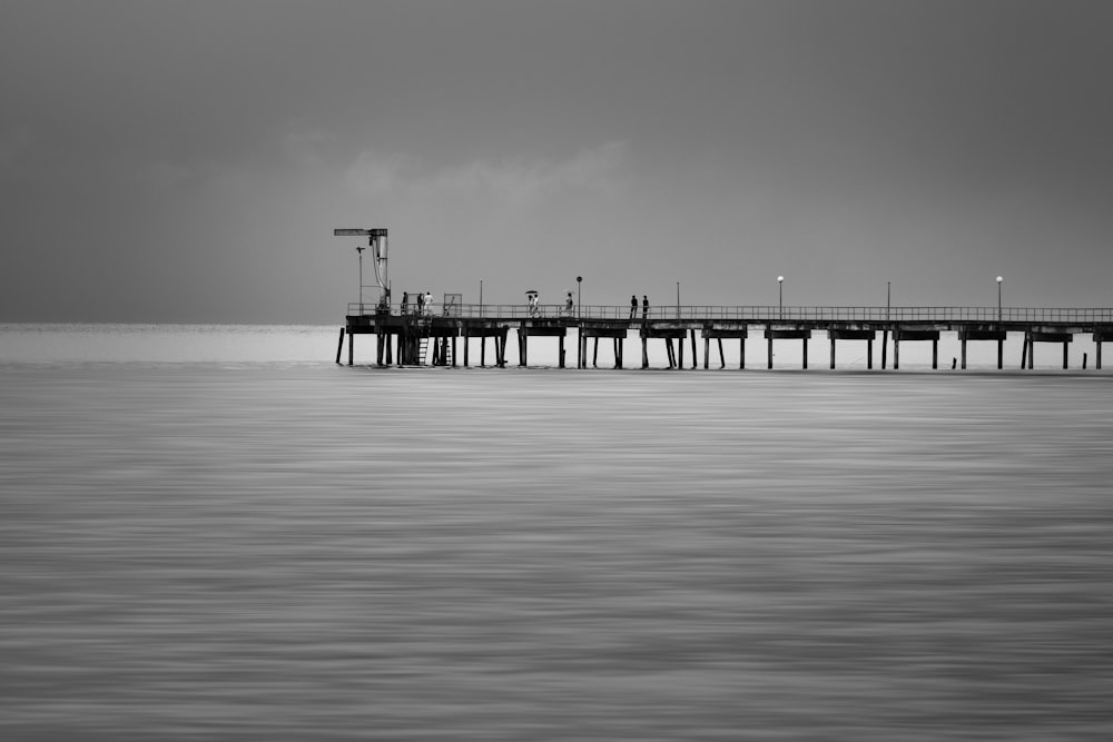 a black and white photo of a pier