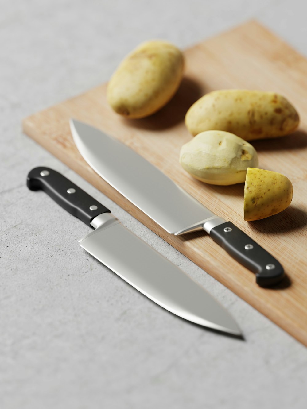 a knife and potatoes on a cutting board