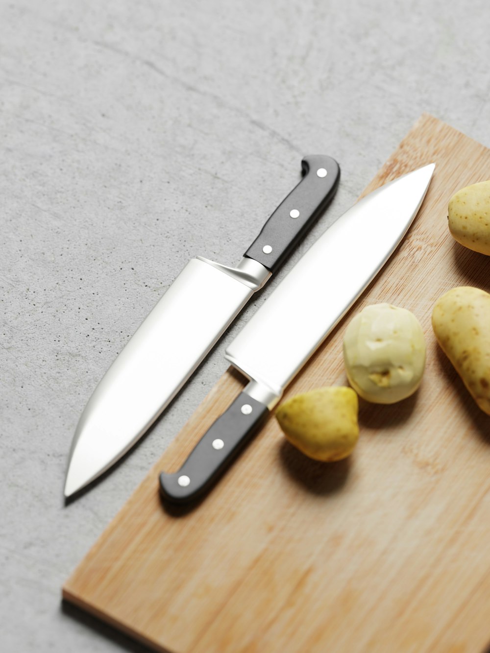 potatoes and a knife on a cutting board