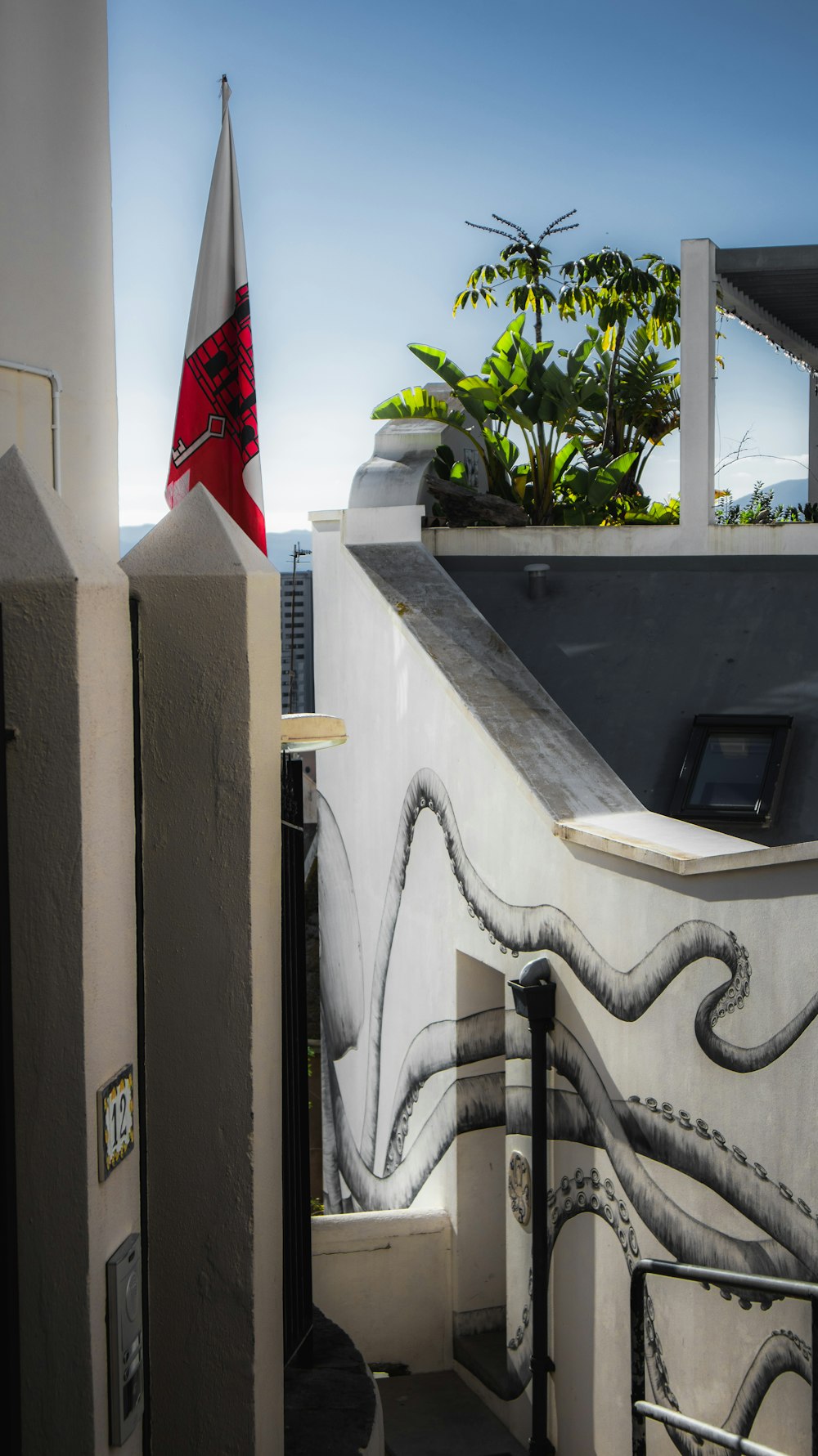 a flag on top of a building next to a fence