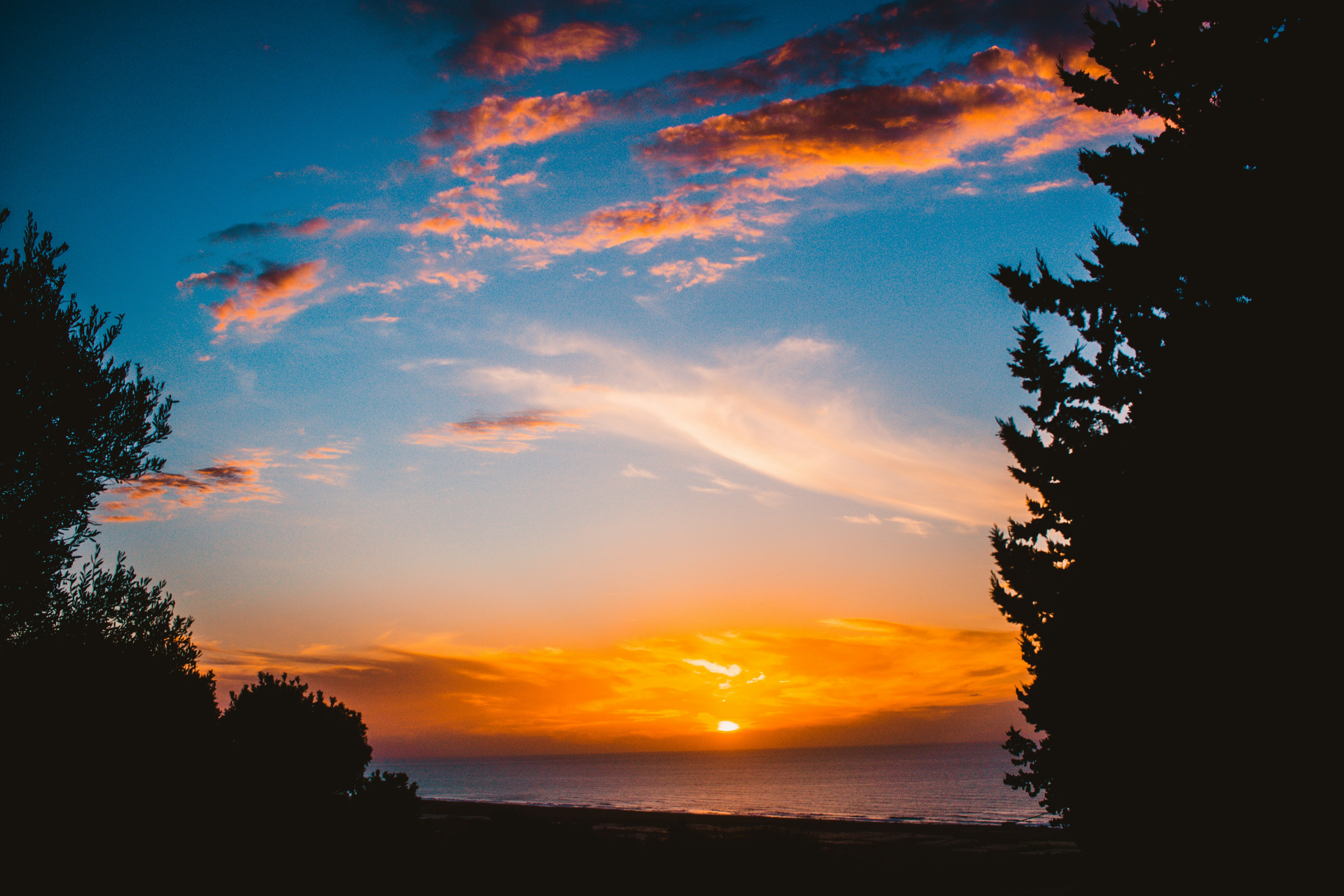 the sun is setting over a body of water