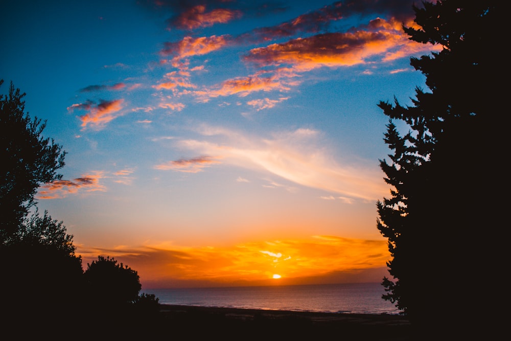 the sun is setting over a body of water