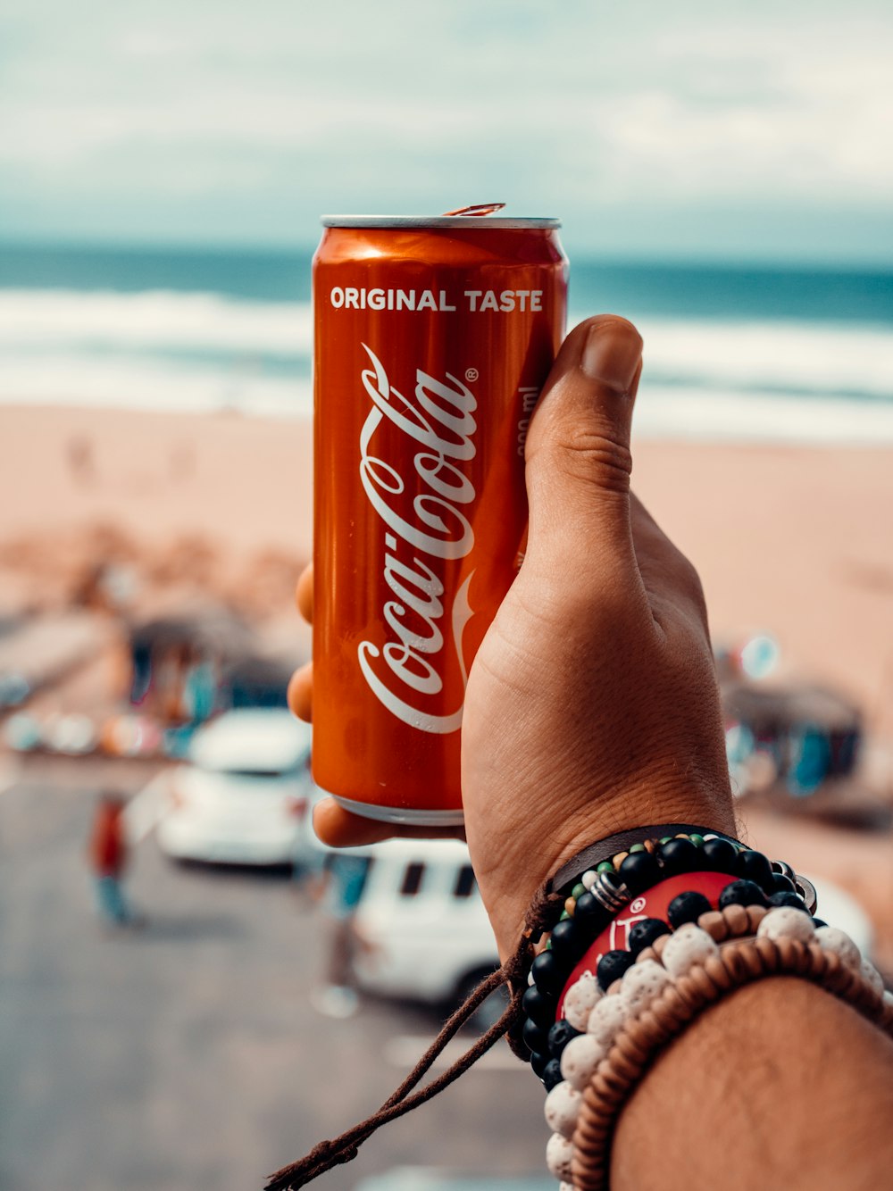 a person holding up a can of coca cola