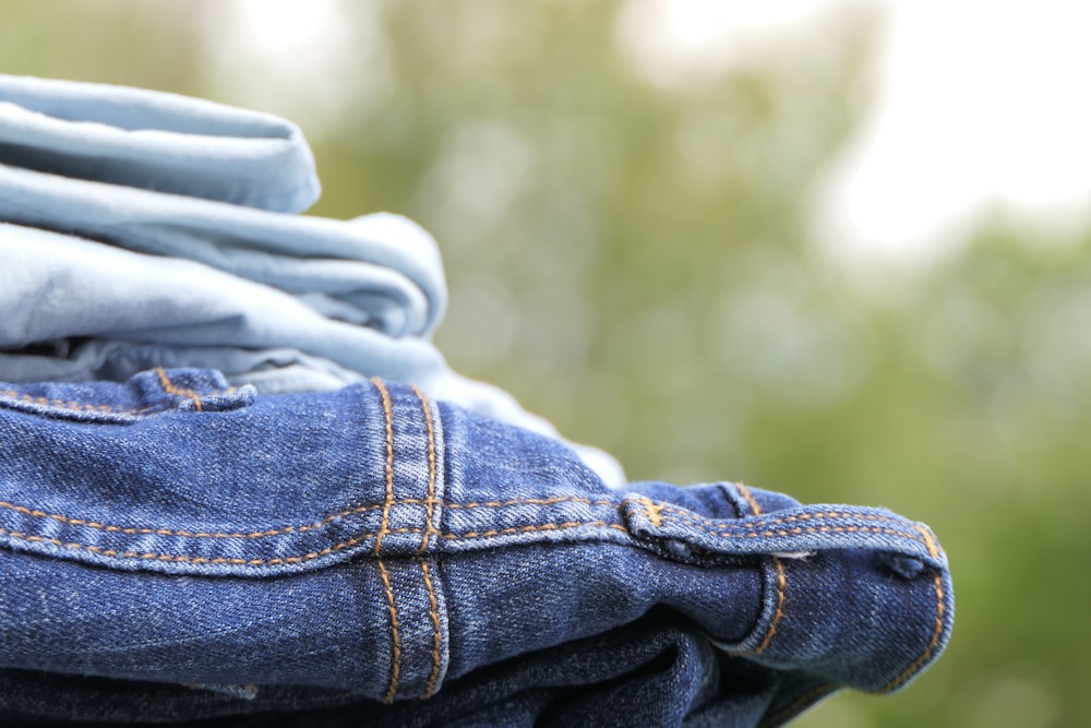 a stack of blue jeans stacked on top of each other