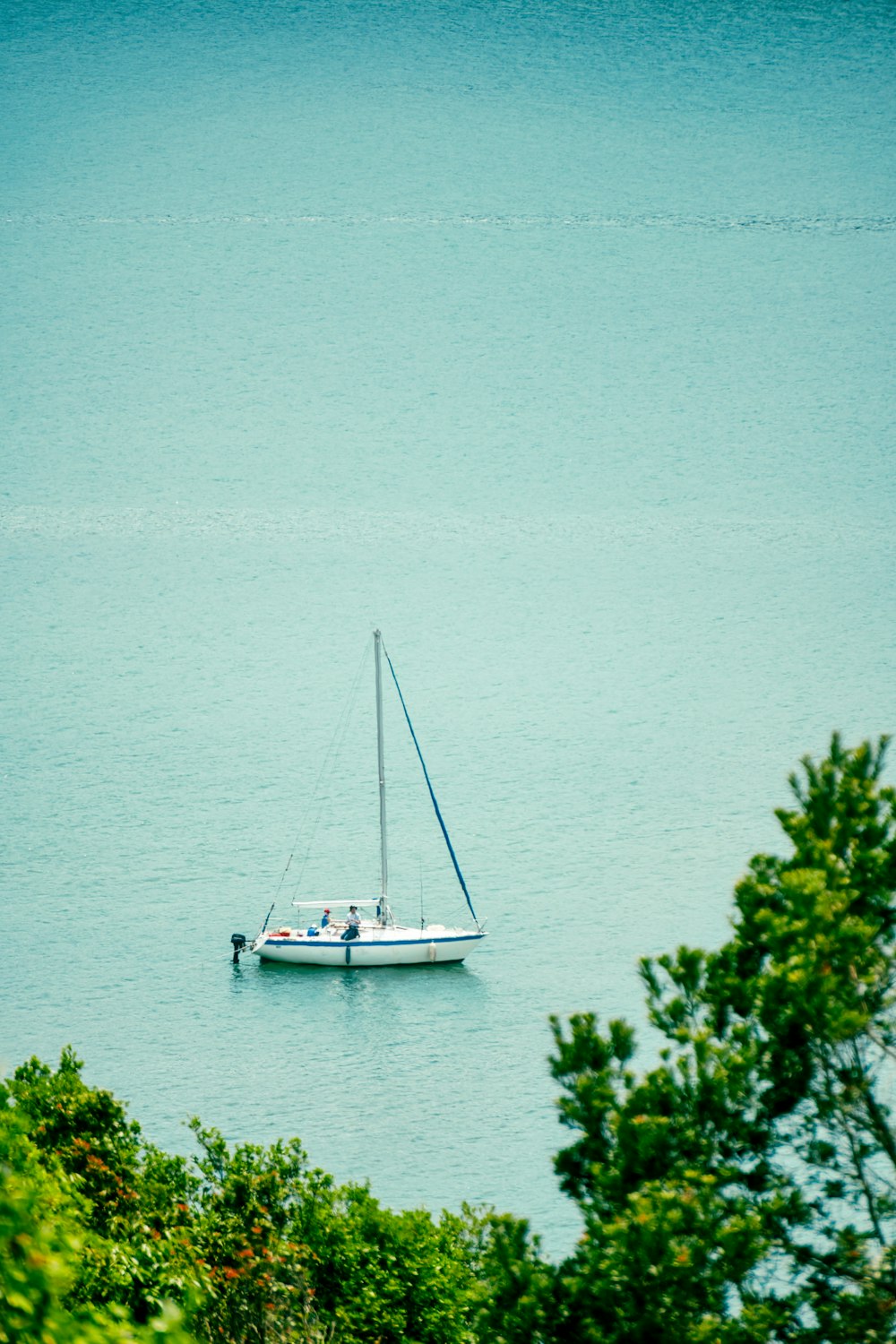 a small sailboat floating on a large body of water