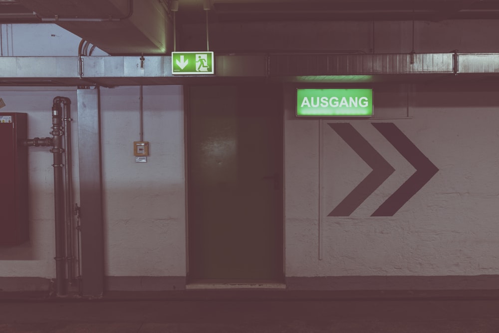 a subway station with a green sign on the door