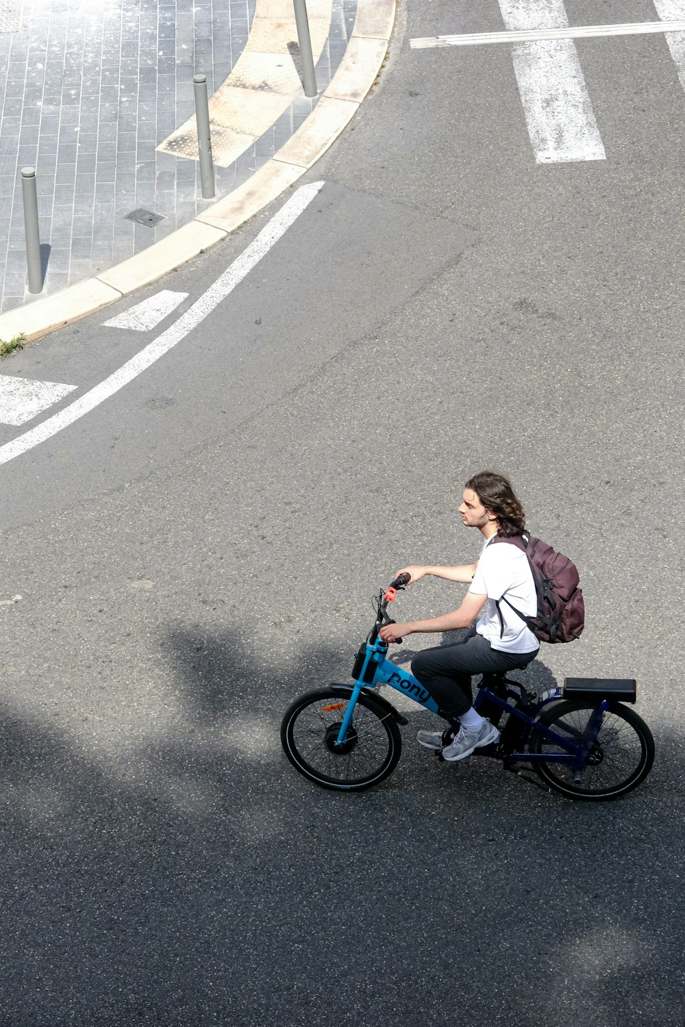 a woman riding a bike down a street