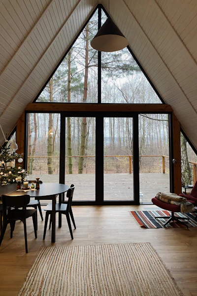 Séjour d'un chalet en A, grande baie vitrée ouverte sur la forêt