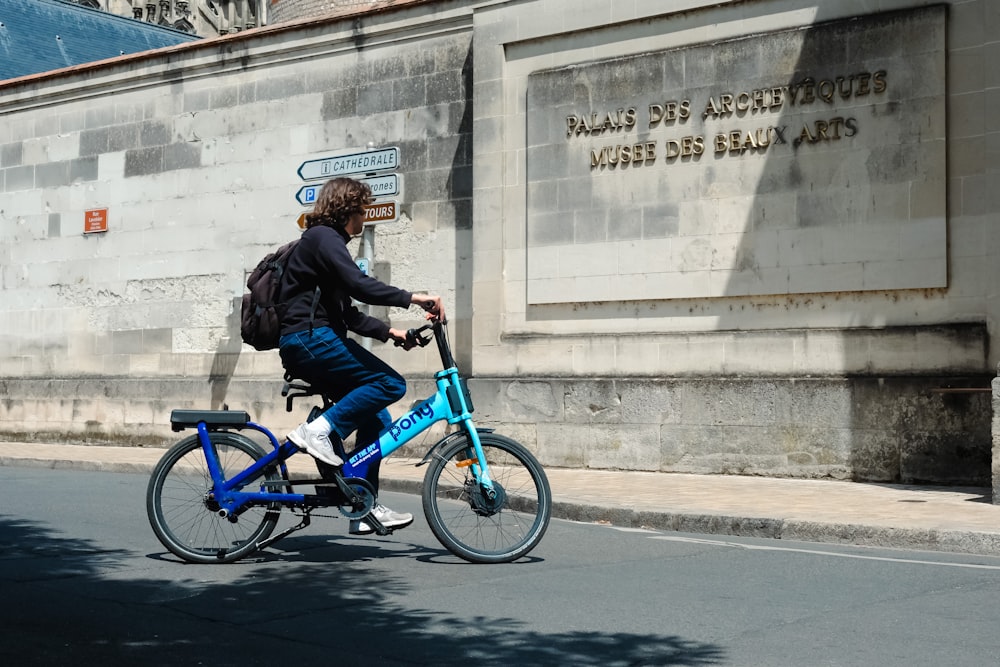 a person riding a bike on a city street