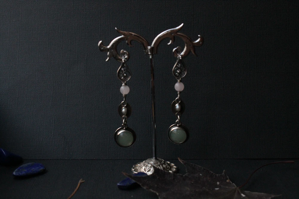 Pair of silver drop earrings with stone accents