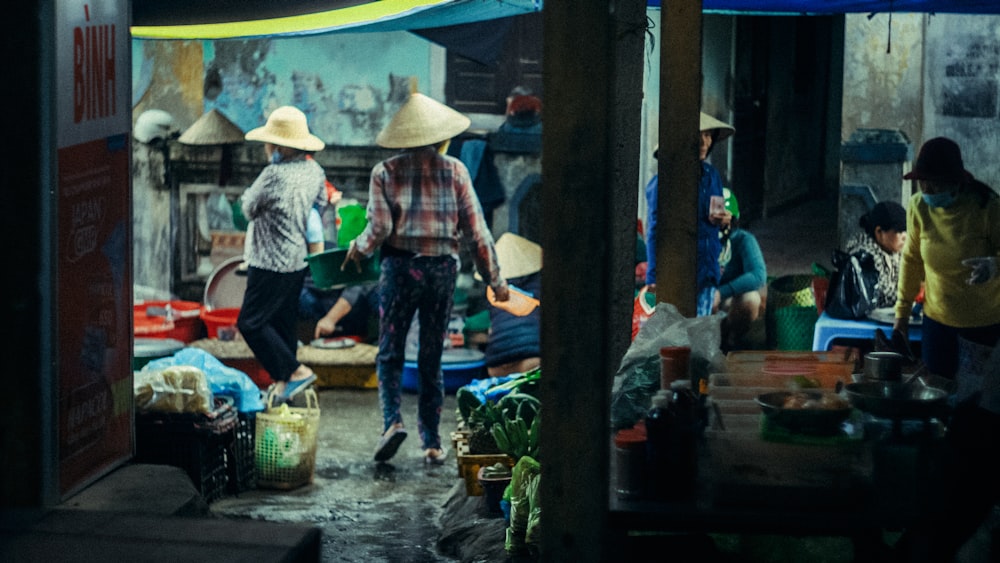 a group of people walking around a market