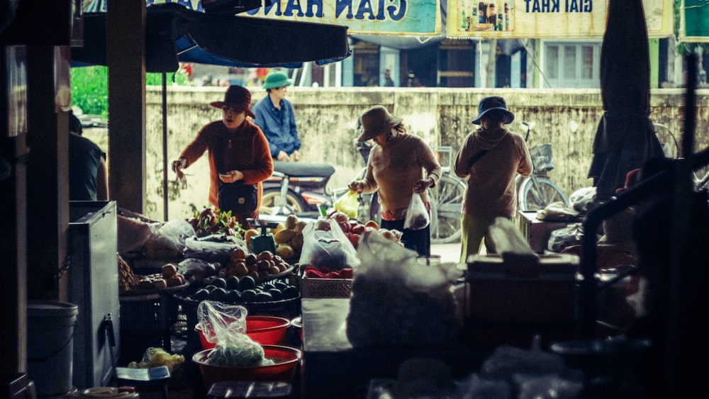 a group of people standing around a market