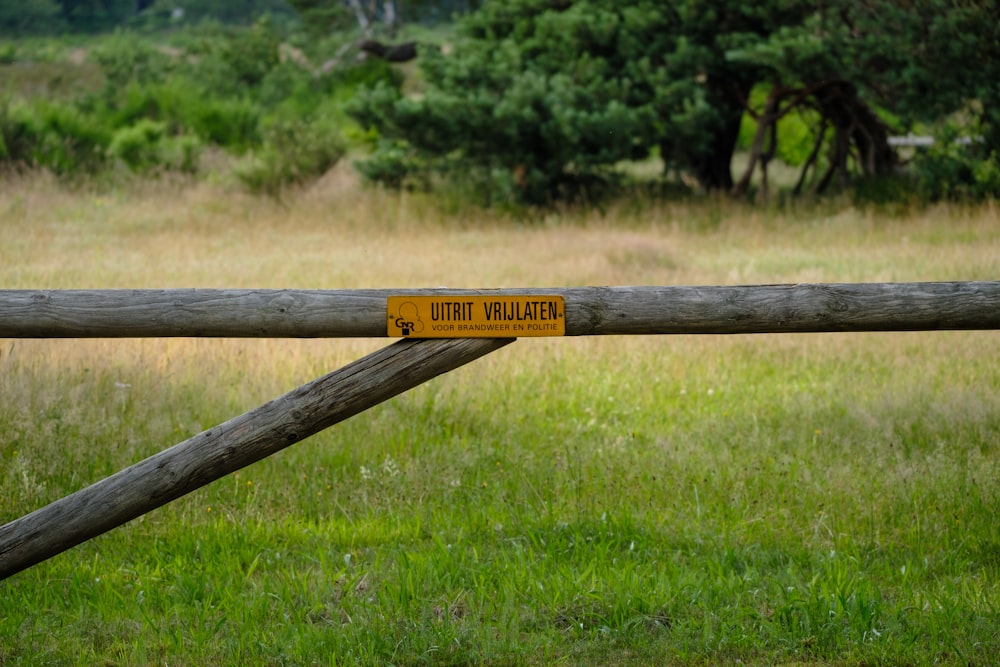 a wooden fence with a yellow sign on it