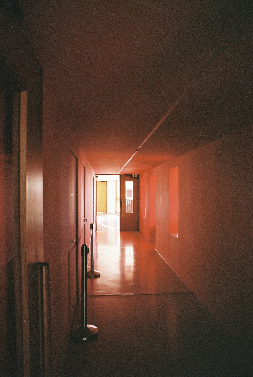 a long hallway with a light coming through the door