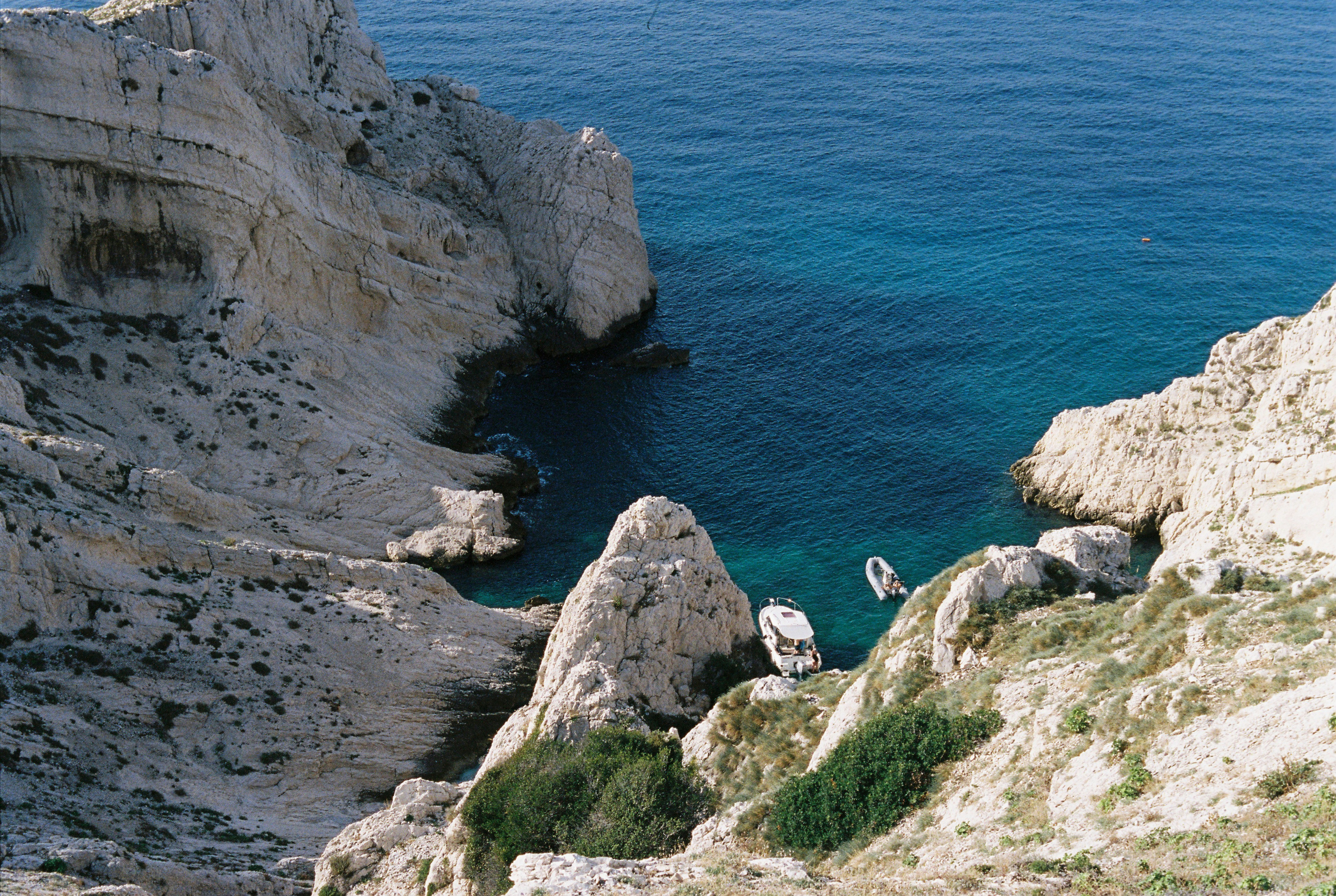 a couple of boats floating on top of a body of water, 