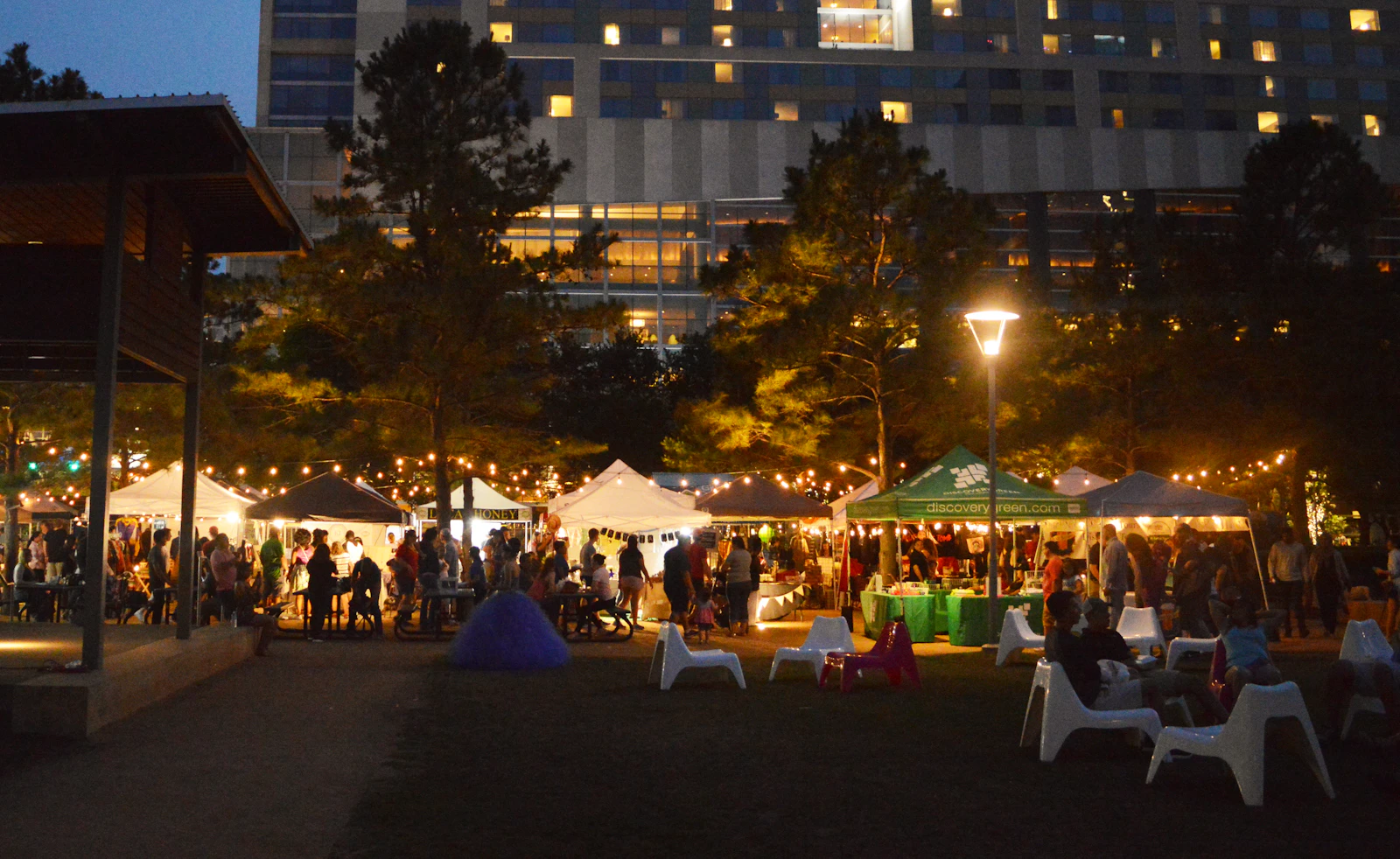 Outdoor festival market stalls under pop-up tents in a park