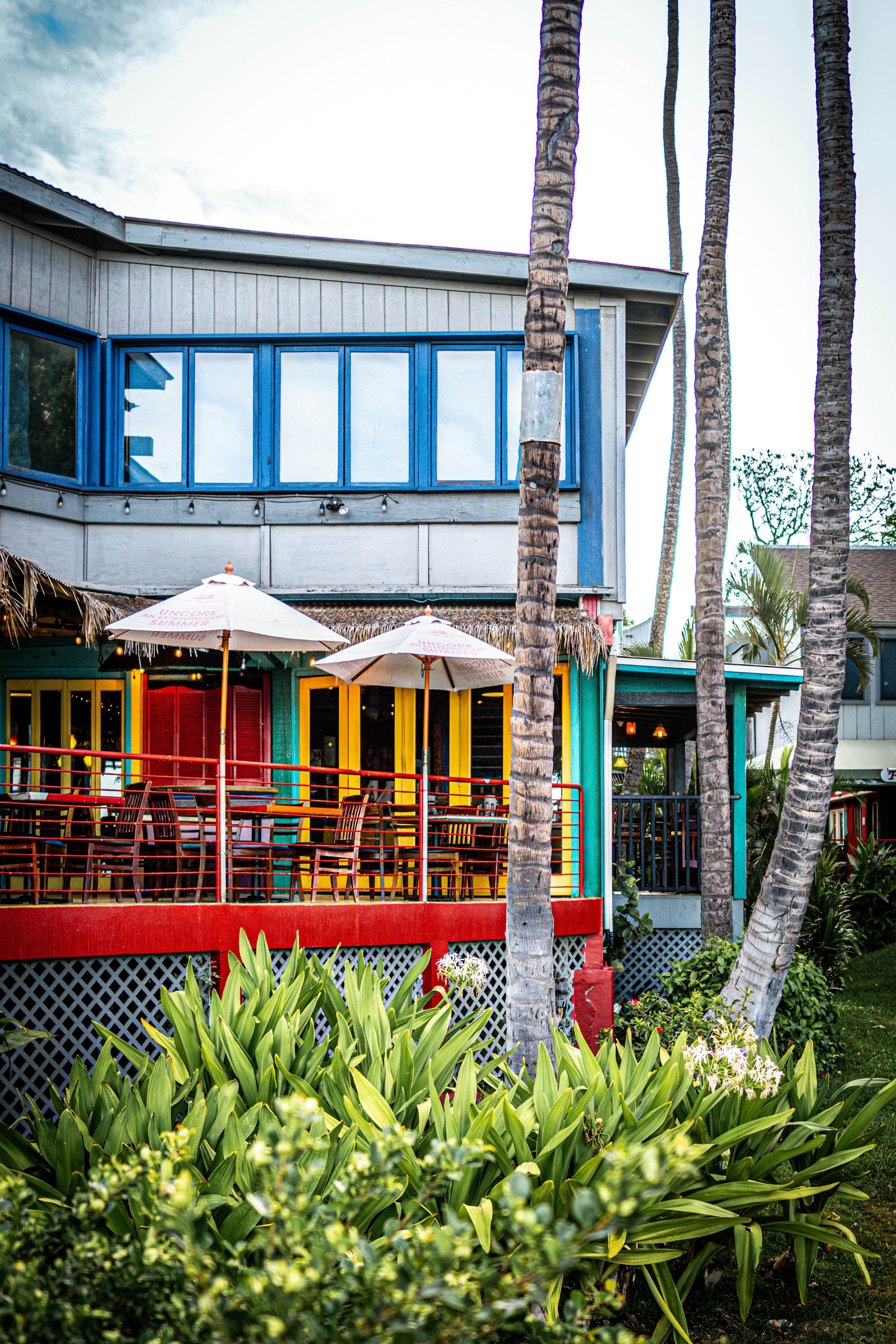 a building with a bunch of tables and umbrellas