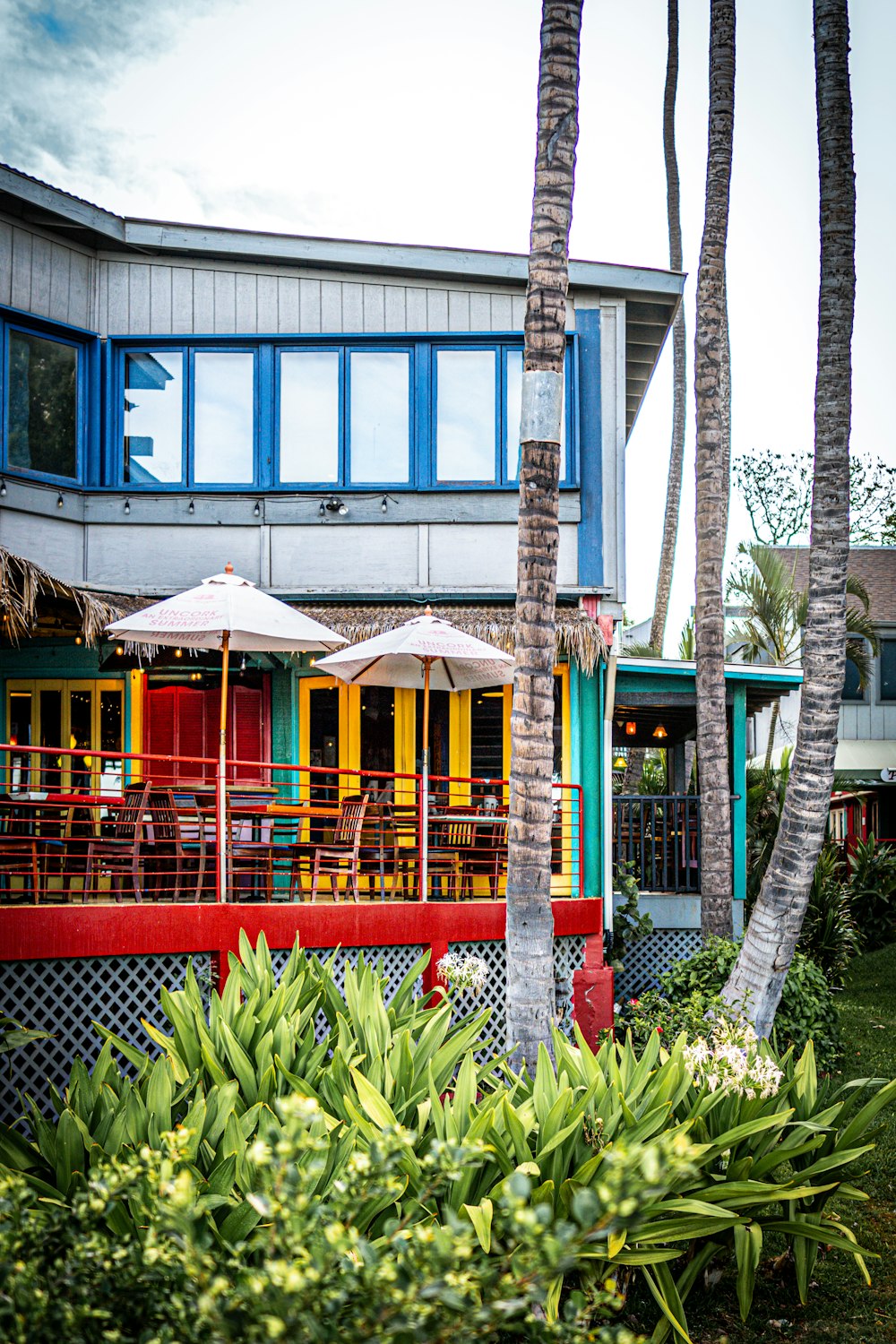 a building with a bunch of tables and umbrellas