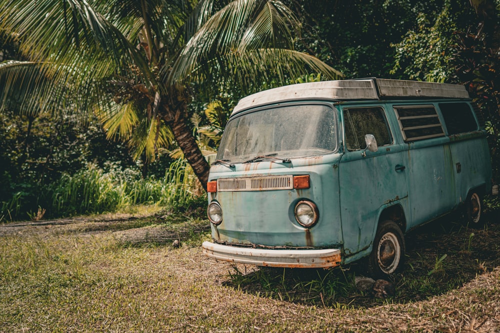 an old van is parked in the grass