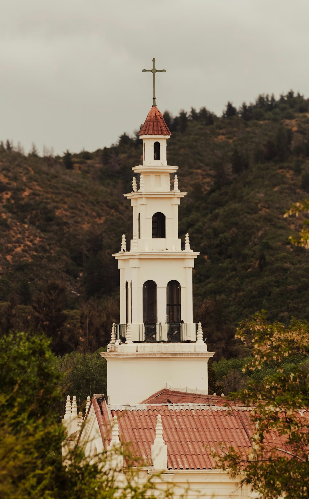 a church steeple with a cross on top of it