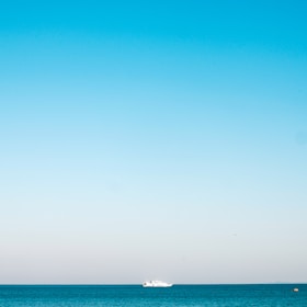 a boat is out in the ocean on a clear day