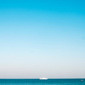 a boat is out in the ocean on a clear day