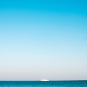 a boat is out in the ocean on a clear day