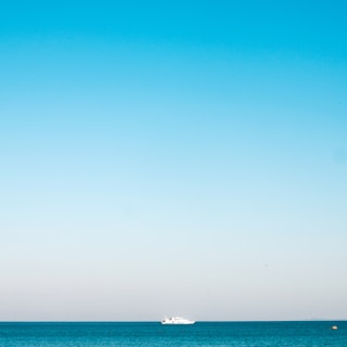 a boat is out in the ocean on a clear day