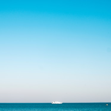 a boat is out in the ocean on a clear day