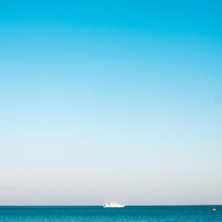 a boat is out in the ocean on a clear day