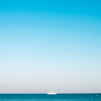 a boat is out in the ocean on a clear day