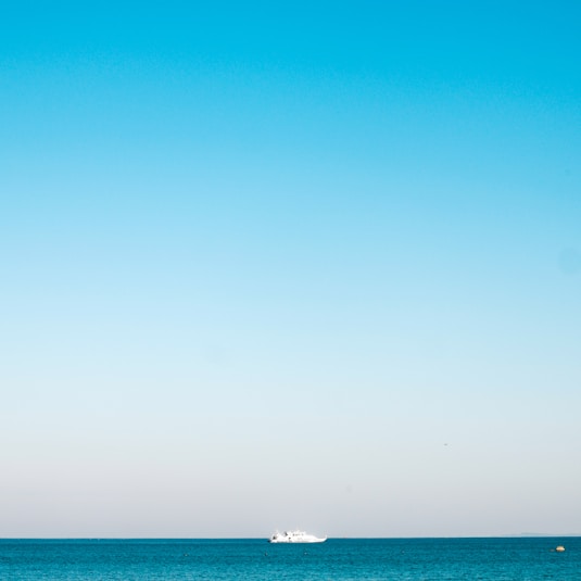 a boat is out in the ocean on a clear day