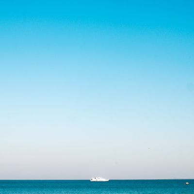 a boat is out in the ocean on a clear day