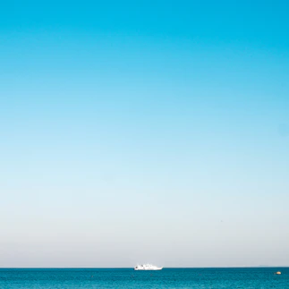 a boat is out in the ocean on a clear day
