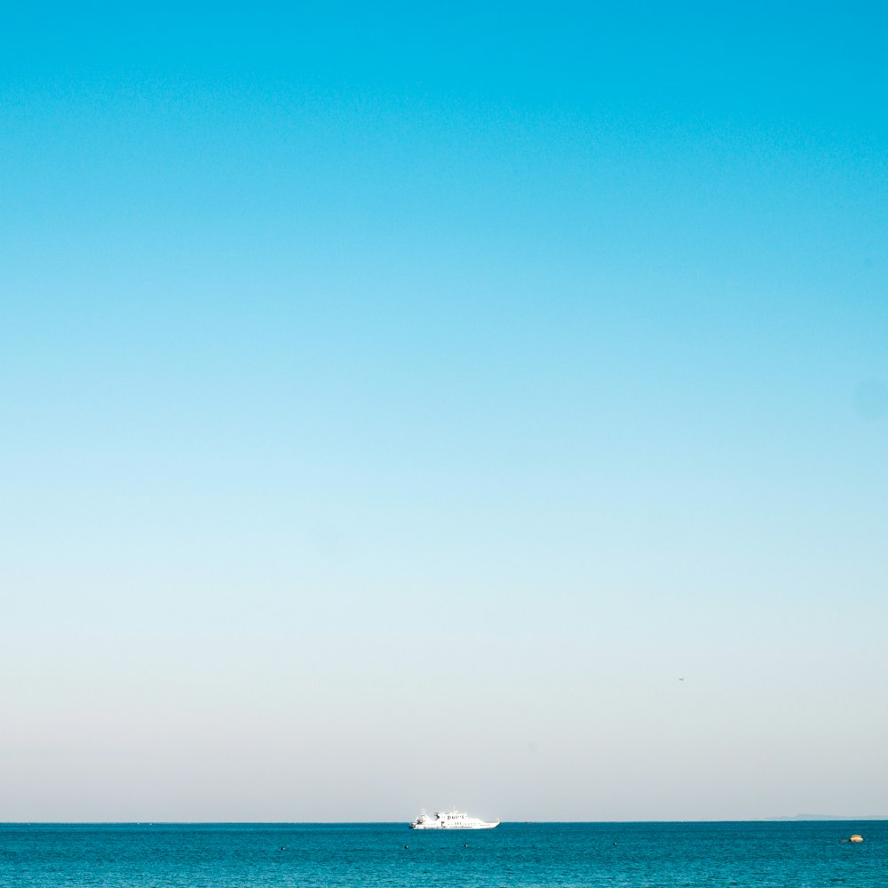 a boat is out in the ocean on a clear day