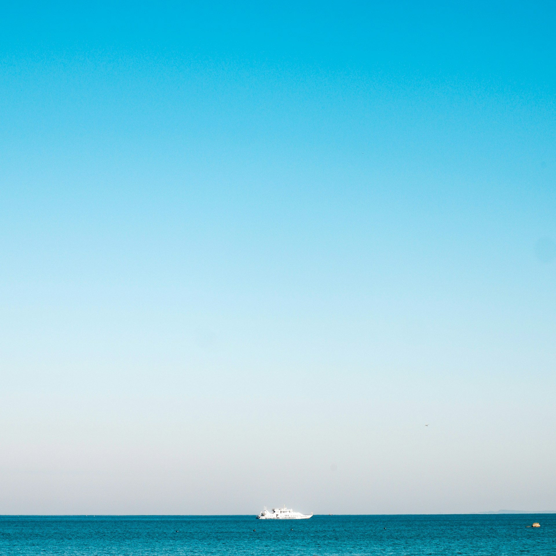 a boat is out in the ocean on a clear day