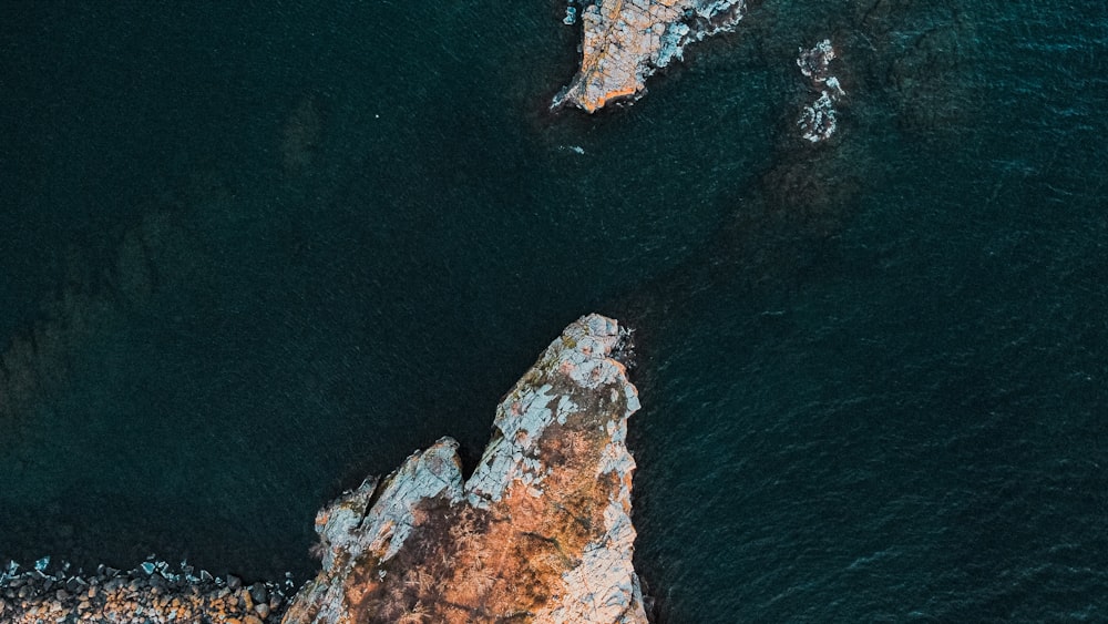 an aerial view of a rock formation in the ocean