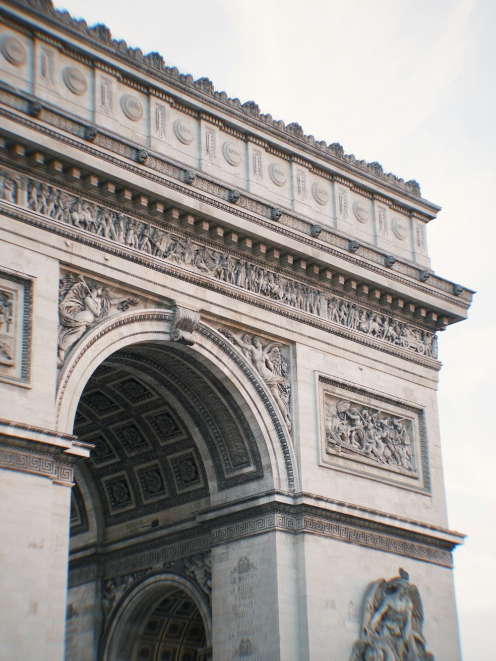 a close up of a very tall building with a clock on it's side