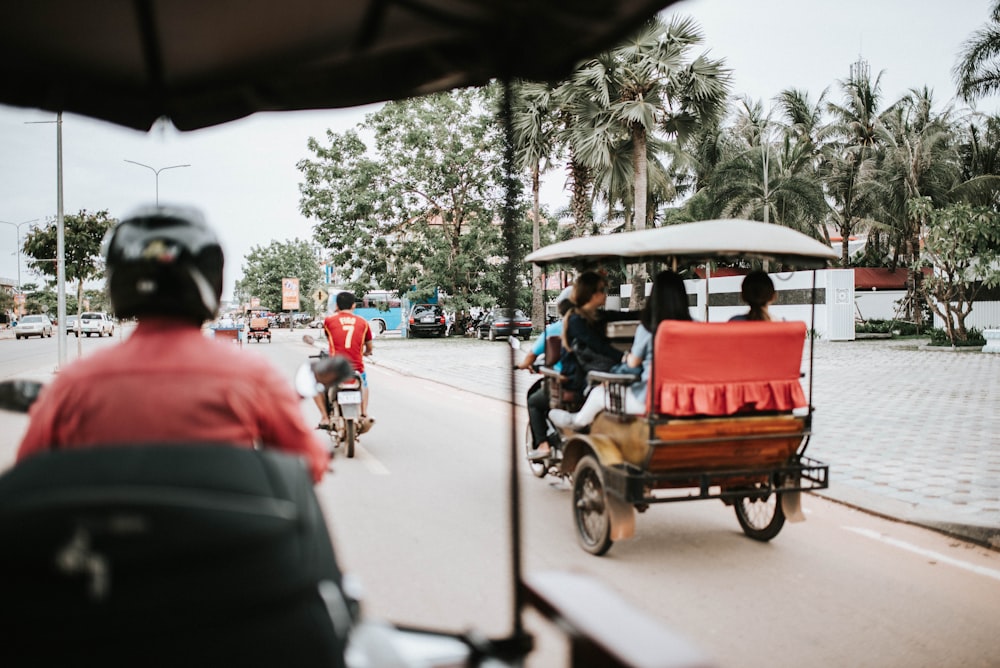 a group of people riding on the back of a motorcycle