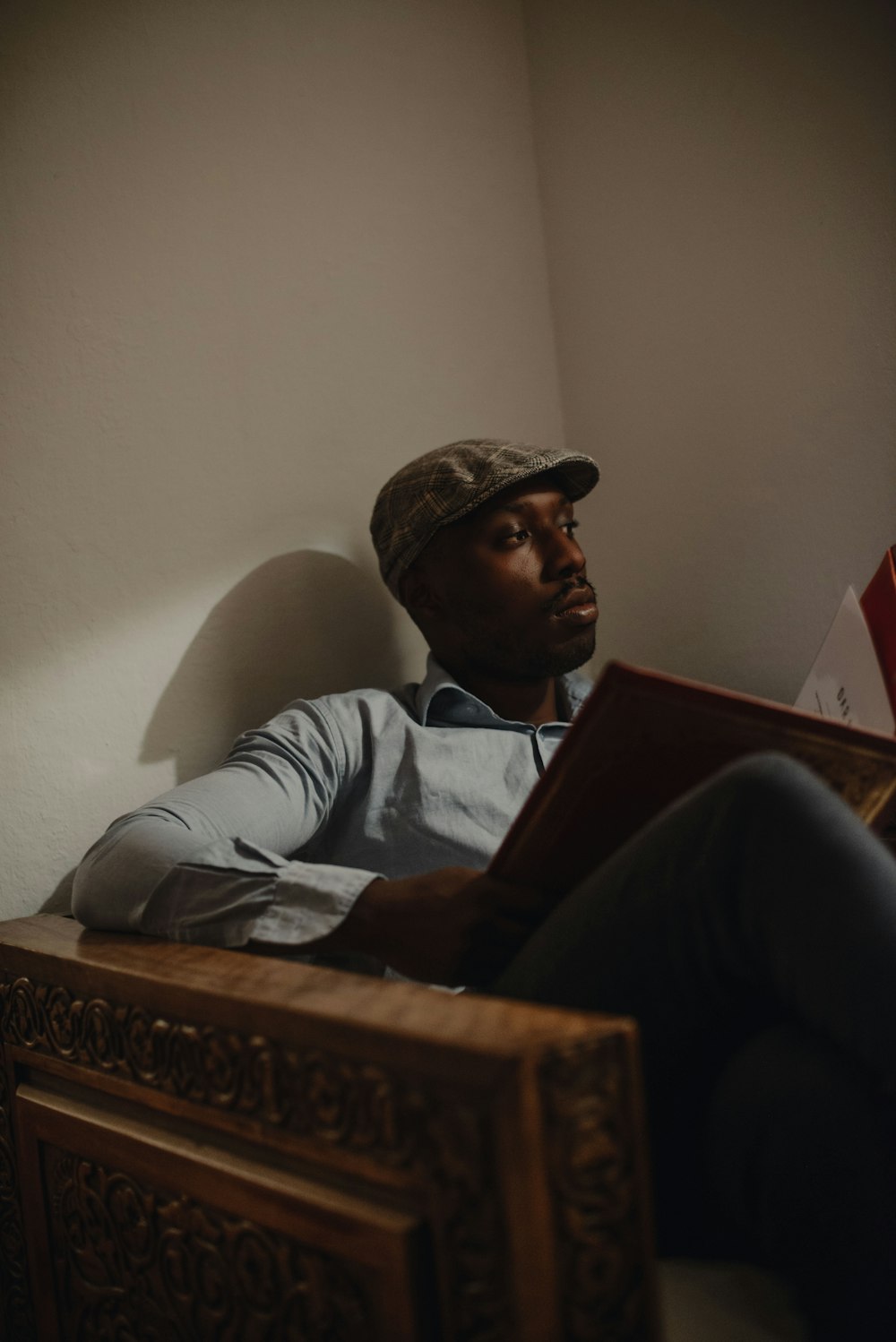 a man sitting in a chair reading a book