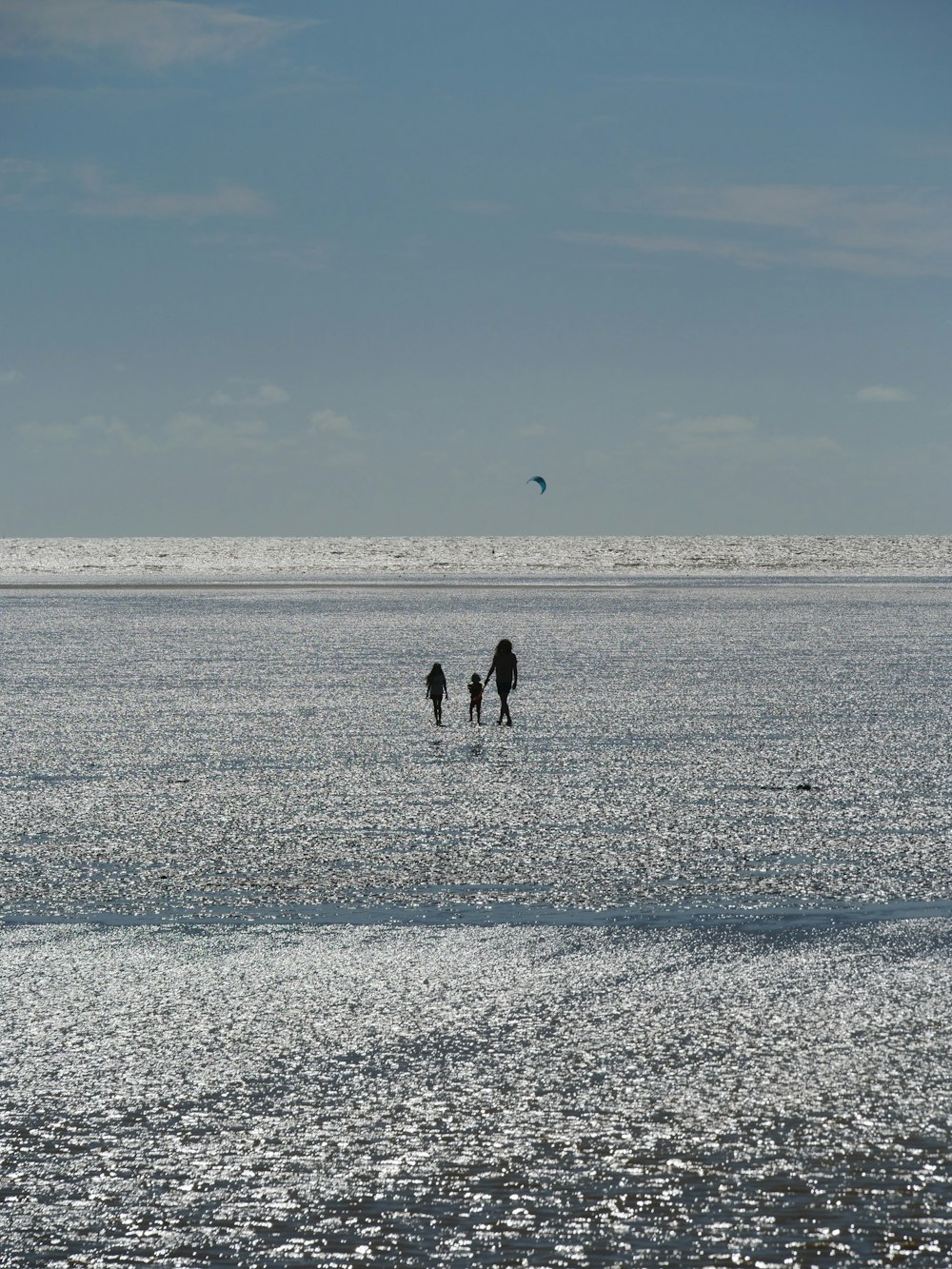 a couple of people walking across a large body of water